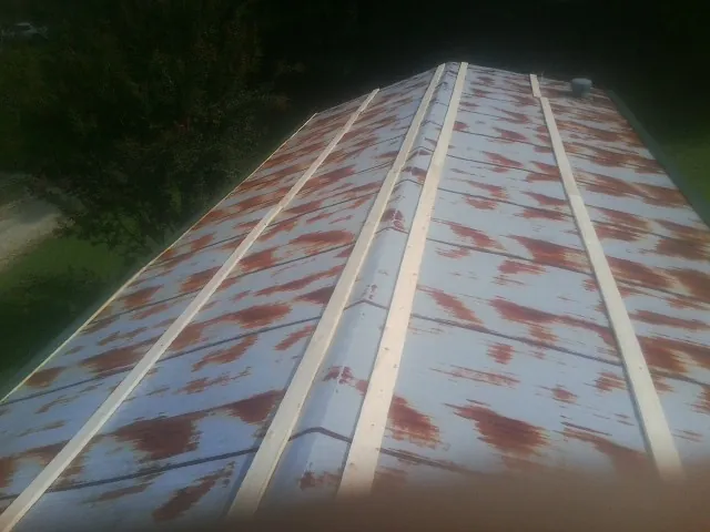 Rusted metal roof panels with new wood purlins before replacement — Storm Damage Roof Repair in Maidens by Roofing Brothers