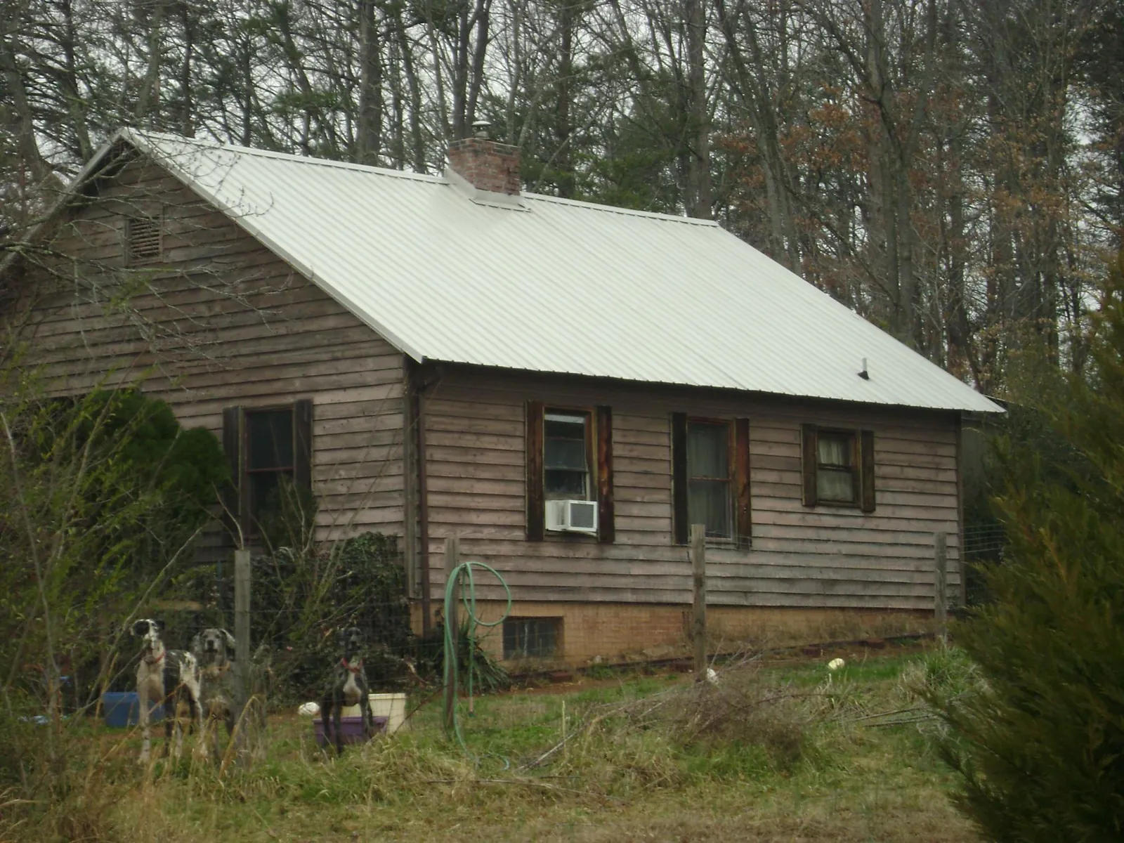White metal roof on an old wood sided farmhouse, from a Asphalt Shingle Roof Repair job in Maidens
